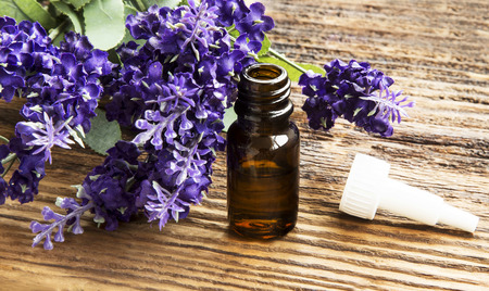 Lavender Essential Oil Bottle on Wooden Backgroundの写真素材