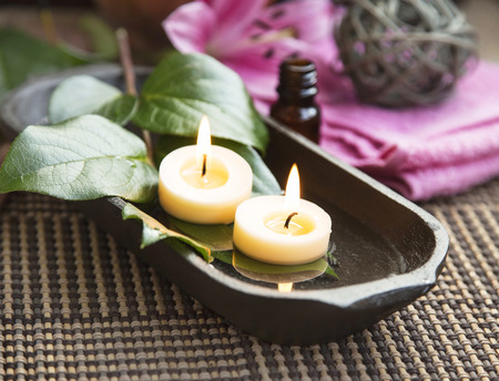 Spa with Floating Burning Candles in a Wooden Water Bowl, Beautiful Calm Settingの写真素材