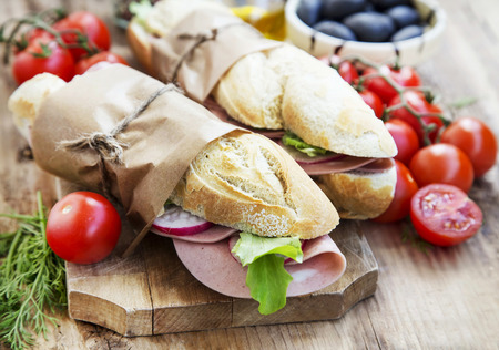 Tasty Ciabatta Sandwiches with Italian Mortadella, Green Lettuce and Radish Slicesの写真素材