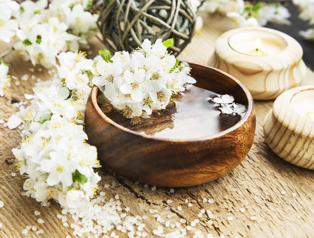 Spa White Flowers Blossom with Wooden Water Bowl on Wooden Background.Wellness and Spa Treatment Conceptの写真素材