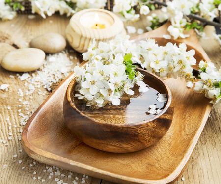 Spa White Flowers Blossom with Wooden Water Bowl on Wooden Background.Wellness and Spa Treatment Conceptの写真素材