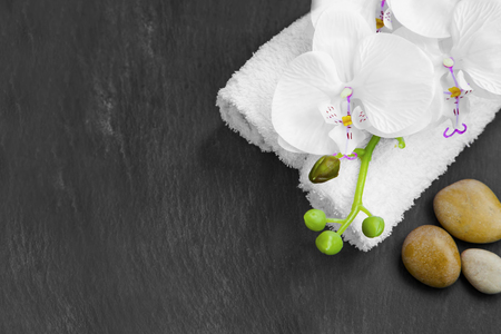 Spa still life with massage stones,white orchid and towels on grey backgroundの写真素材