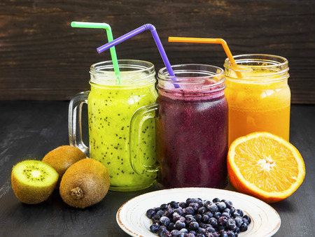 Healthy fruit juices with green kiwi,blueberries and orangeの写真素材