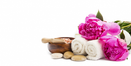 Spa setting with pink peonies, cotton towels , massage stones isolatedの写真素材