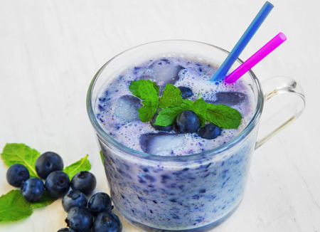 Fresh iced blueberries smoothie with fresh mint leaves and blueberry fruitsの写真素材