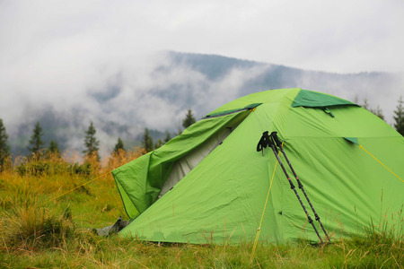 Camping tent outdoor in the nature wilderness with forest and mistの写真素材