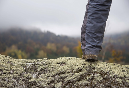 Hiker leg outdoor standing on mountain peakの写真素材