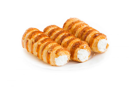 Cream rolls pastry. Horns filled with cream isolated