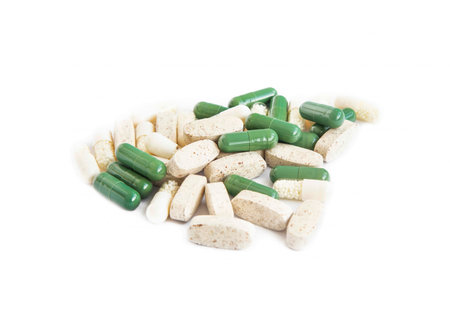 Heap of medical pharmaceutical pills isolated on white