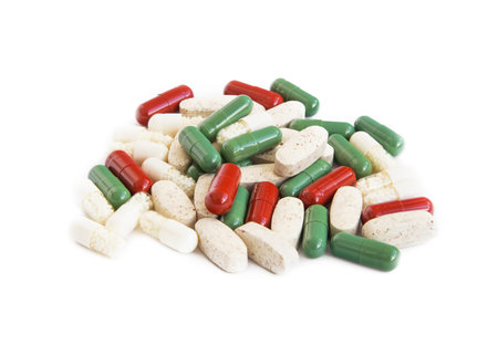 Heap of medical pharmaceutical pills isolated on white