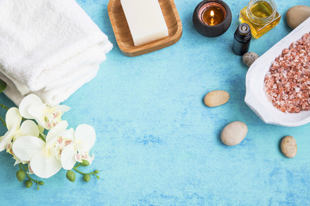 Spa set frame with towels, orchid flower, honey , soap,salt , massage stones for body treatmentsの写真素材