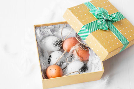 Box with Easter eggs and feathers decorations