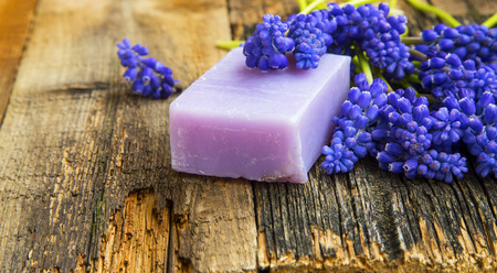 Natural handmade soap with purple flowers on wooden backgroundの写真素材