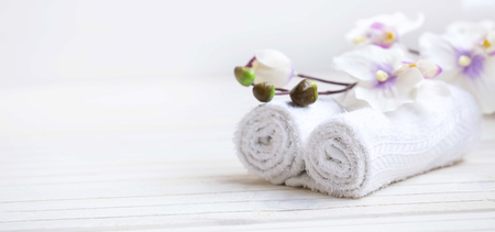 SPA setting with bath towels and orchid flower, selective focusの写真素材