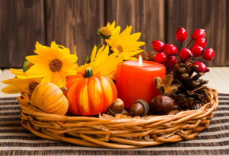 Autumn decoration arrangement with candle, flowers, pumpkins 
