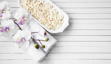 SPA setting with white orchid flower, bath salt and towels, overhead shotの写真素材