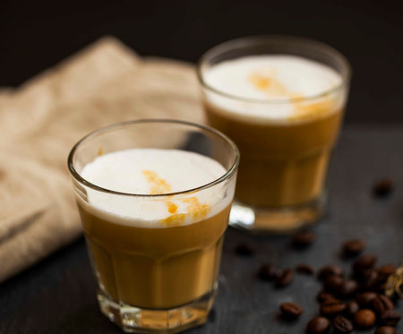 Espresso latte coffee glasses with milk foam and coffee beans , selective focusの写真素材