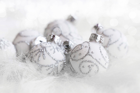 Festive glittery silver Christmas balls closeup, winter season Christmas balls decorations in faux furの写真素材