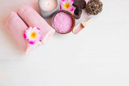 Spa setting top view with body products, body care wellness with plumeria,cotton towels, bath salt,...