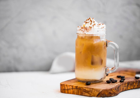 Ice coffee cup with cream. Ice  summer refreshing coffee drink with cream