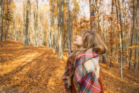 Young girl in autumn season in the park, girl with scarf in fall outdoor, dreamy beautiful fall conceptの写真素材