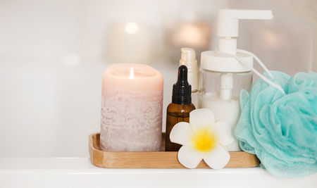 Spa setting still life with candle, body oils and frangipani flower, spa and aromatherapy still lifeの写真素材