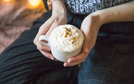 Woman holding coffee with cream, still life setting of woman holding cappuccino coffee cup