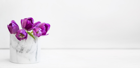 Spring purple tulips bouquet in a vase on white background, spring flowers bouquetの写真素材