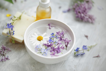 Spa still life with flowers, natural soap and oil bottle, spa bowl closeup, natural beauty and wellness setting , aromatherapy treatmentの写真素材
