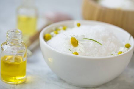 Spa still life with bath salt, chamomile flowers and oil bottle, spa and wellness products, home spa  closeup products, body and skin care productsの写真素材