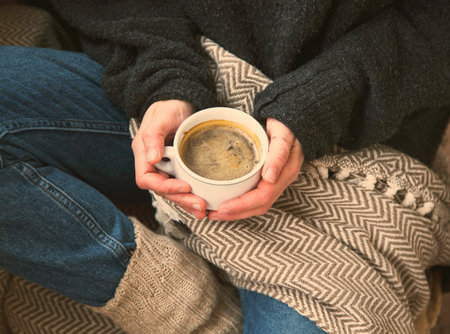 Autumn coffee cup with cozy blanket, fall deco warm home weekend with coffee cup,woman holding...