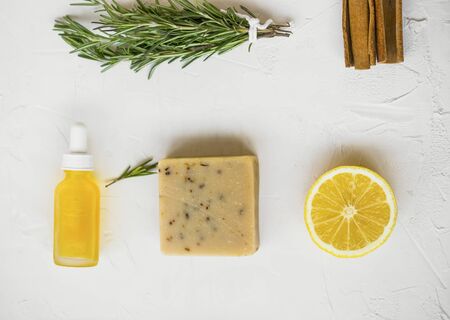 Clean beauty. Natural spa products with rosemary herb, lemon, oil bottle,natural cinnamon soap, natural home skincare products, homespa and wellness clean beauty productsの写真素材