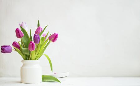 Spring tulips bouquet wi white vase with copy spaceの写真素材
