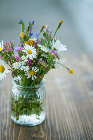 Still life flowers bouquet in a vase on wooden table, interior decorationの写真素材
