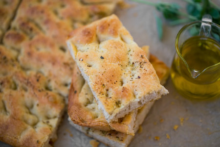Focaccia bread, italian traditional homemade bread, fresh bread with olive oilの写真素材