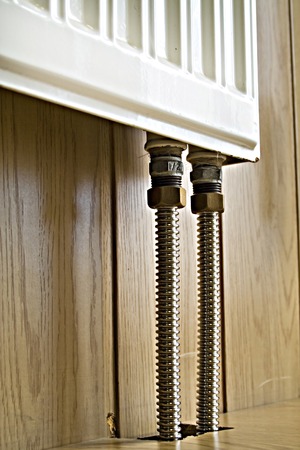 Aluminum pipe and heater on the wooden backgroundの写真素材