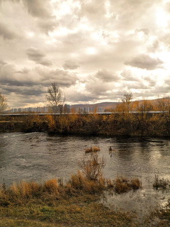 Autumn landscape with river and cloudy sky. Russia, Siberiaの写真素材