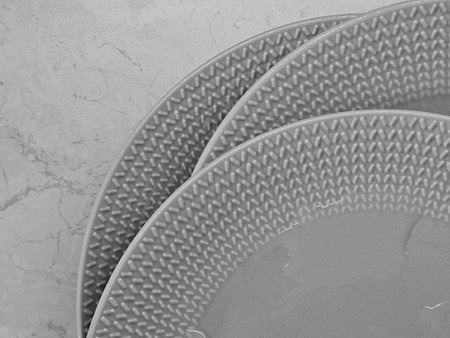Plates on the table, close-up. Black and white.