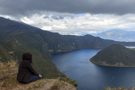 View on a tourist at vulcano lake cuicocha close to otavalo, ecuadorの写真素材