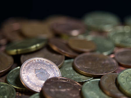 Bulk of european coins with closeup on black background with copy spaceの写真素材