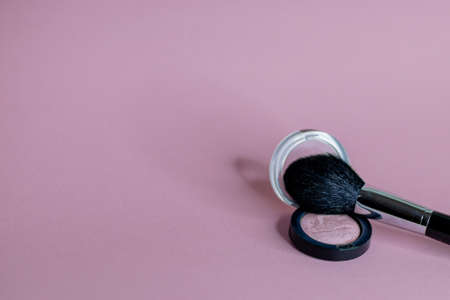beautiful pink blush and black brush on a uniform background close upの写真素材