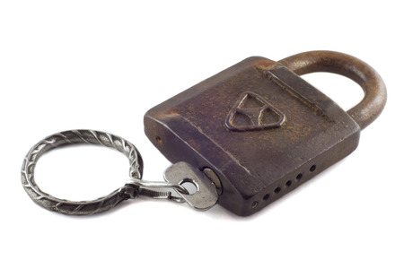 Old padlock with key isolated on whiteの写真素材