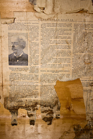 Old yellowed newspaper on a wooden boardのeditorial素材