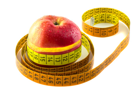 fresh apple with measuring tape. isolated over whiteの写真素材