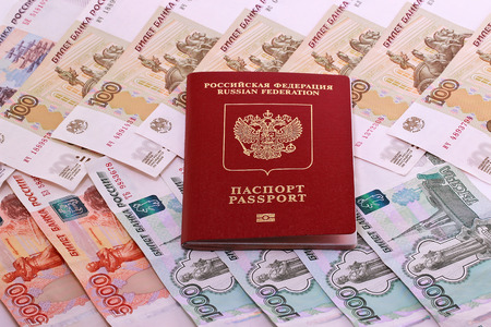 Russian passport on the background of the Russian moneyの写真素材
