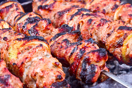 Juicy slices of meat with sauce prepare on fire (shish kebab).の写真素材