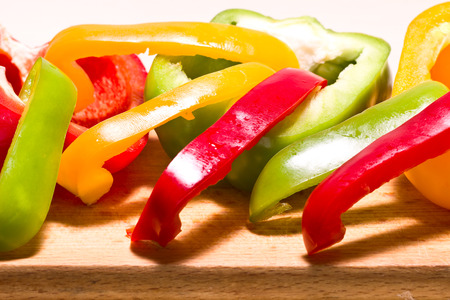 Closeup image of sliced red, green and yellow peppersの写真素材