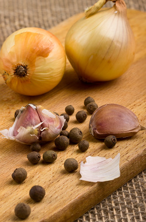 Garlic on a cutting board and bell pepperの写真素材