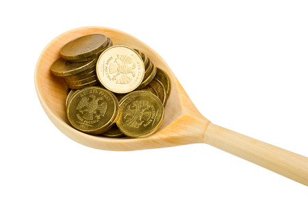 Wooden spoon with coins on a white backgroundの写真素材