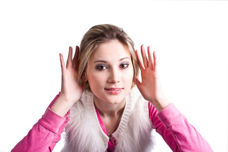 A portrait of a carefully listening to someones conversation, nosy, curious young woman, isolated on...